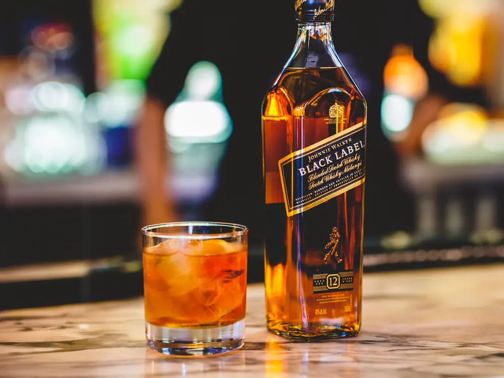 Bar counter with a bottle and cocktails, brand content photography